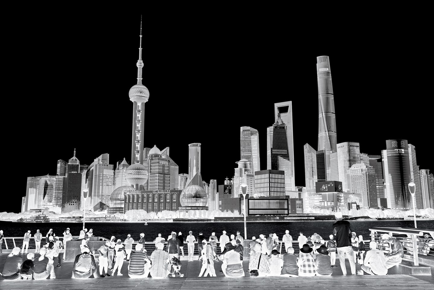 Viewers take in the Shanghai skyline from the Bund waterfront.