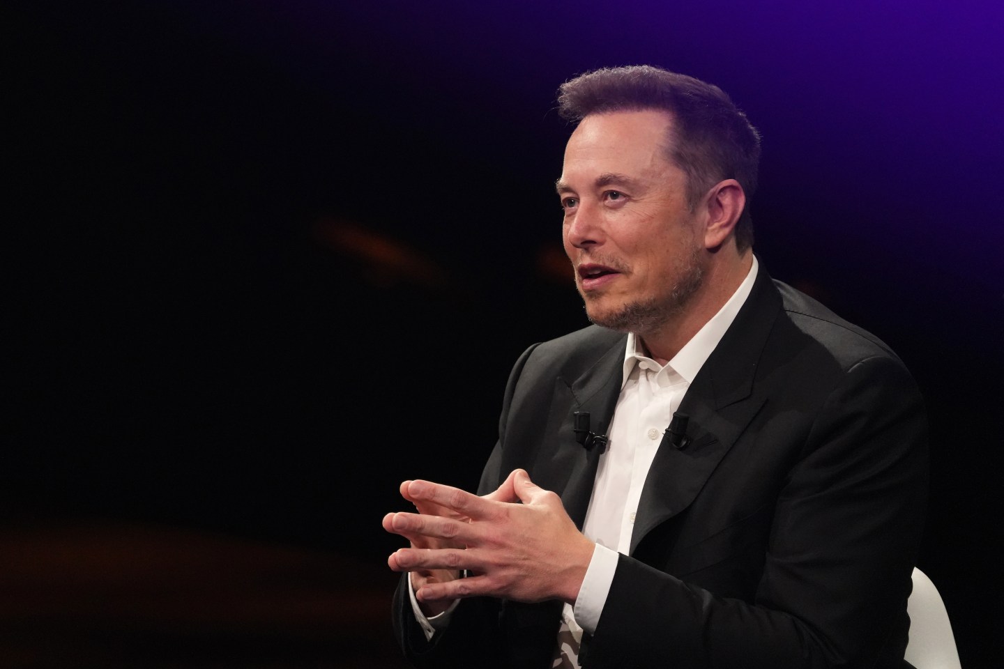 Elon Musk speaking at a conference in Paris.